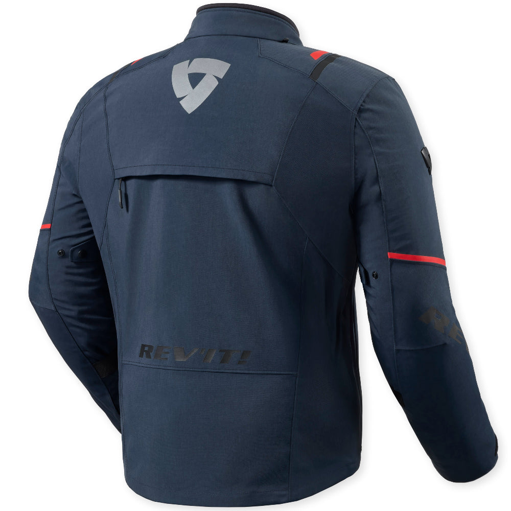 A dark navy blue motorcycle jacket shown from the back, featuring a silver geometric logo on the upper back, a zippered pocket, and subtle red accent stripes on the sleeves.