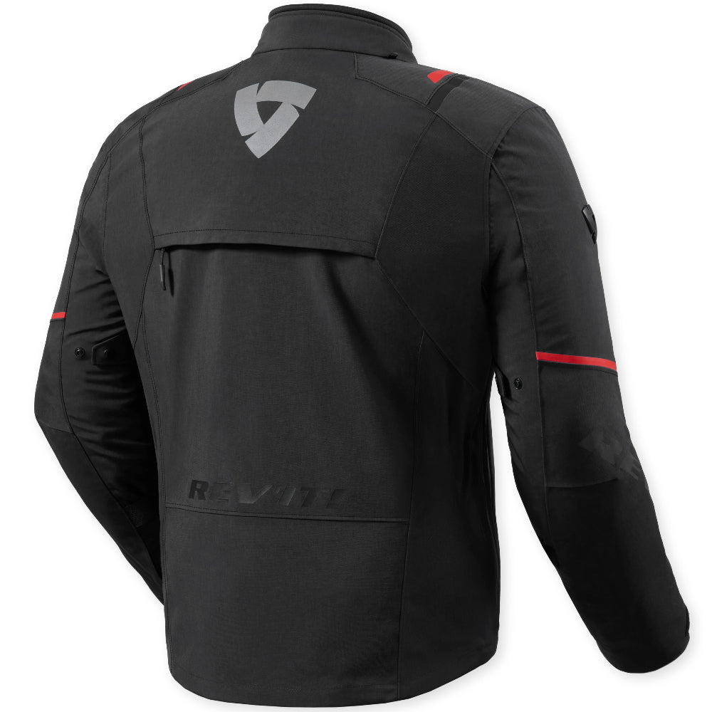 Black motorcycle jacket shown from the back, featuring a gray shield logo on the upper back, subtle red accent stripes on the sleeves, and a tonal brand name near the lower back, set against a light off-white background.