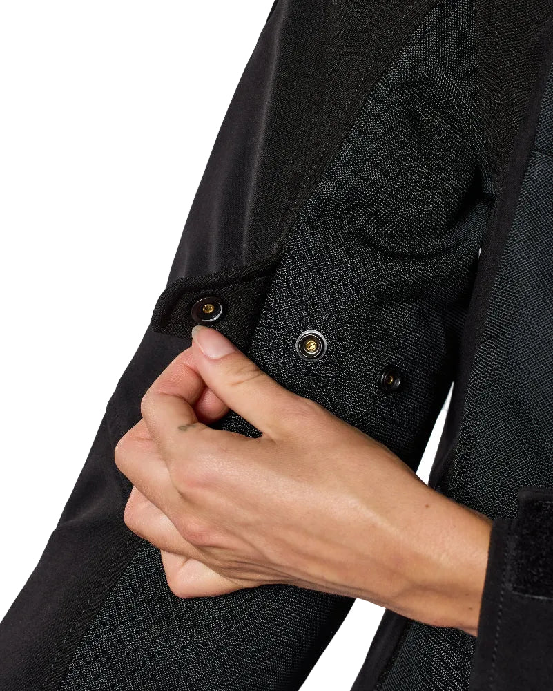 Close-up of a person wearing a black jacket with buttons, on a white background
