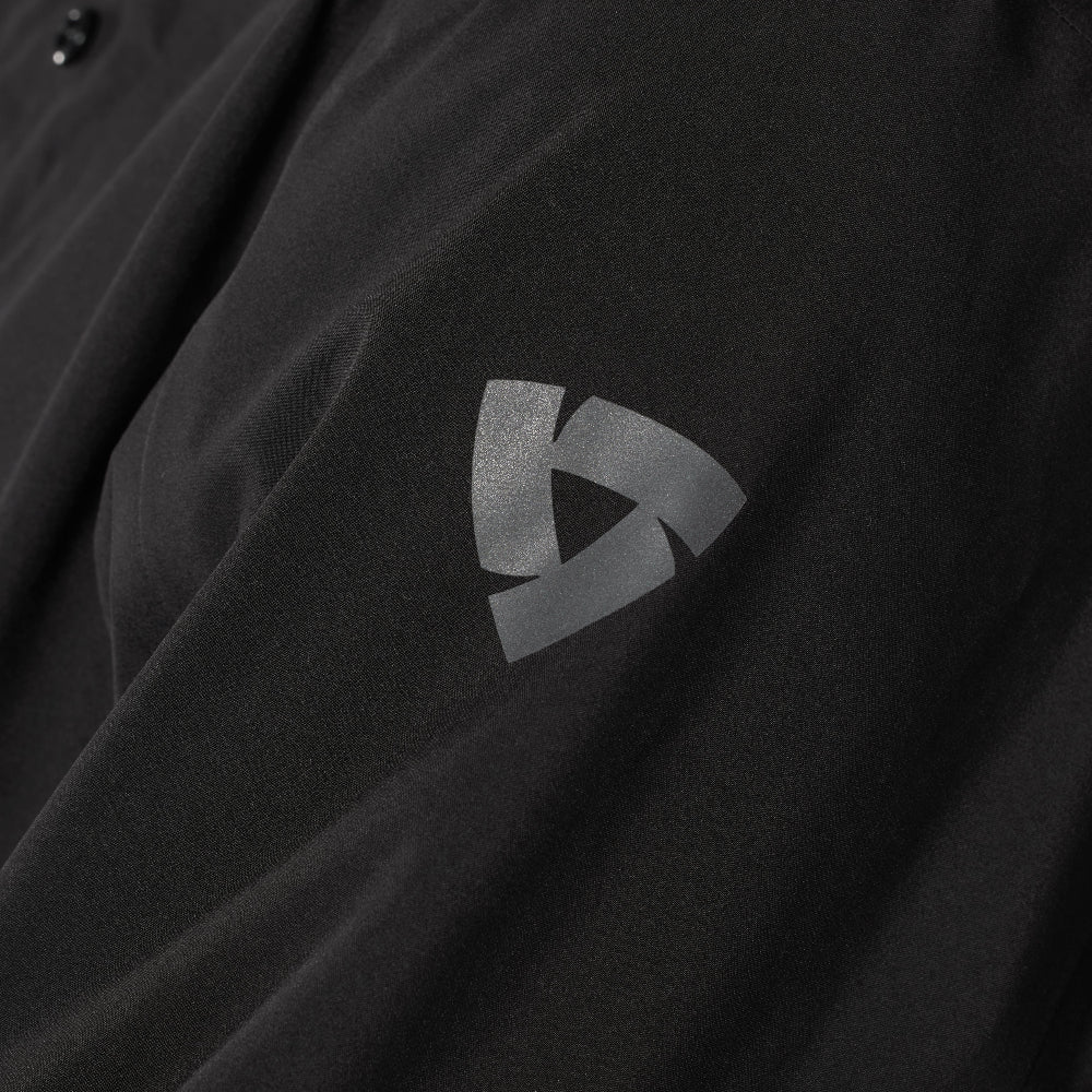 Black shirt with a logo on the sleeve