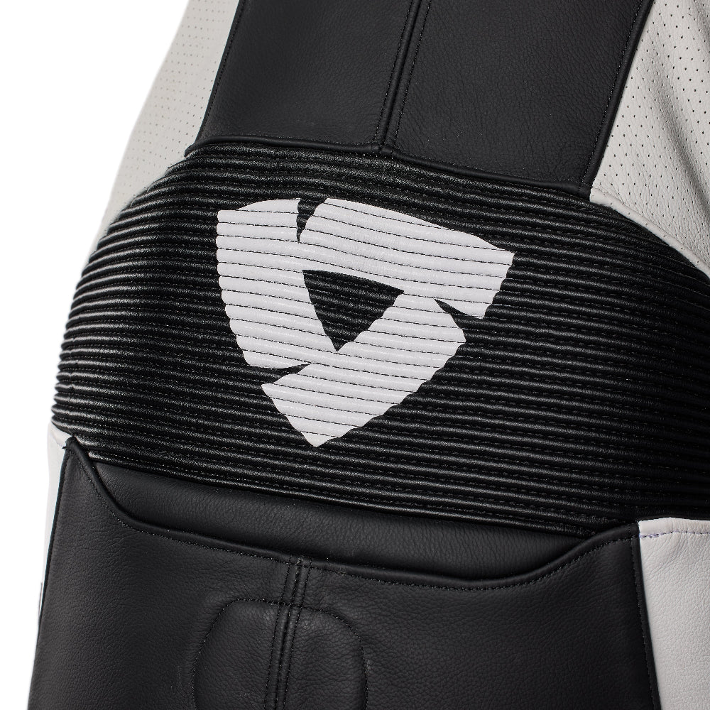 Close-up of a black protective gear garment with a wide black elastic band featuring a white geometric shield logo, set against a white background.
