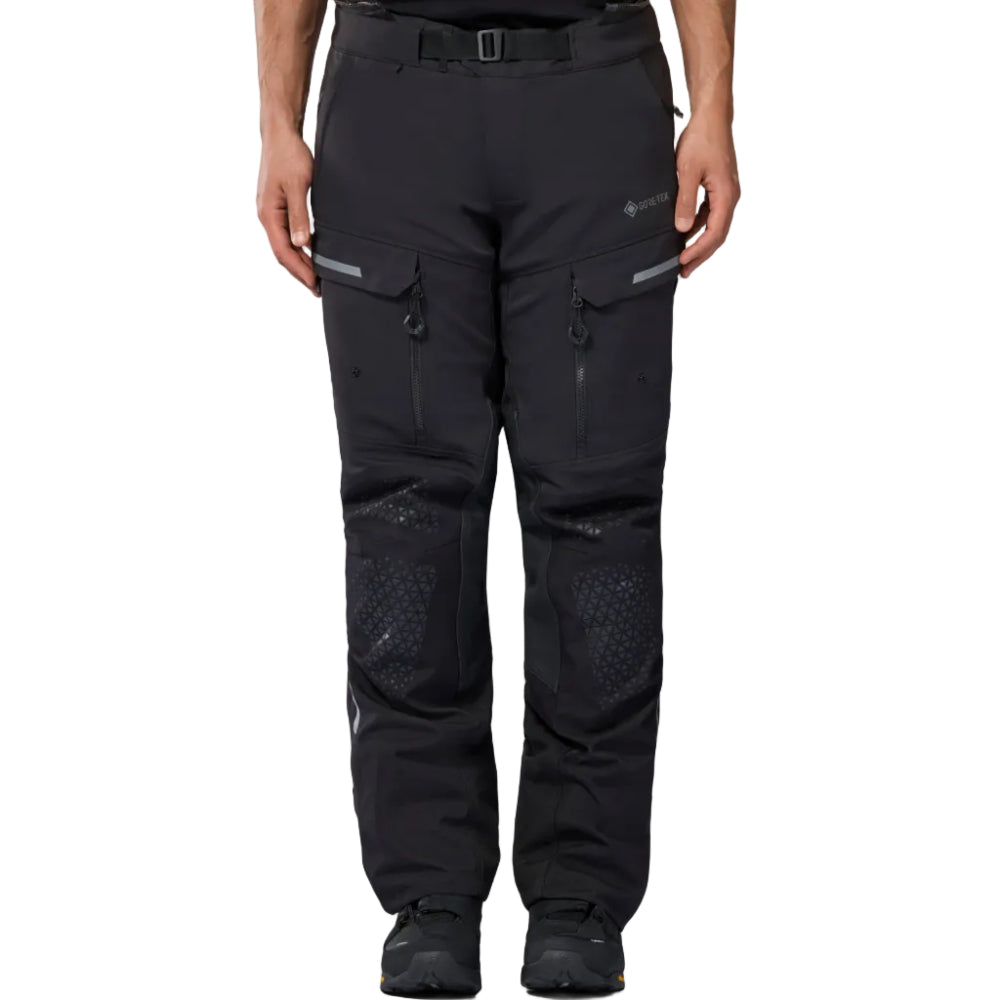 Black technical outdoor pants with zippered vents and textured knee panels, shown on a model from the waist down against a white background.