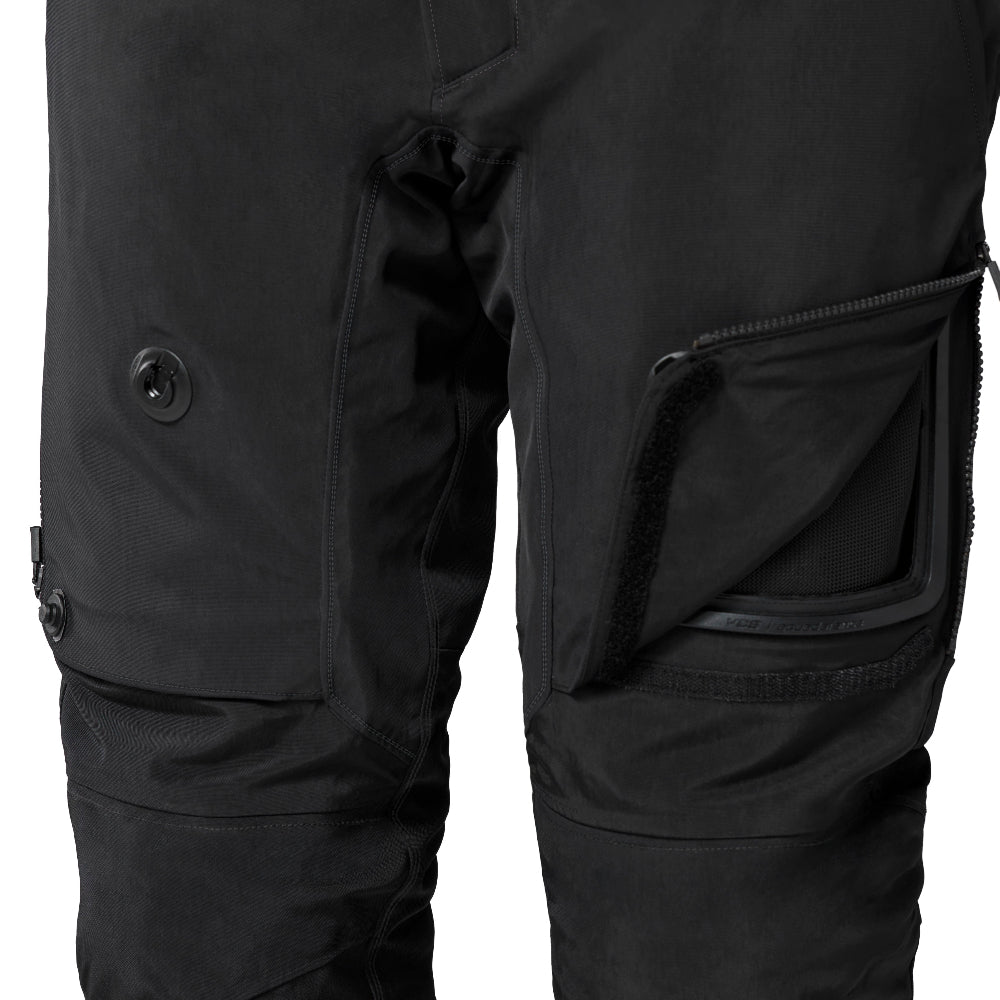 Close-up of black cargo pants showing the right thigh area with a zippered pocket, a button detail, and a side flap pocket against a white background.