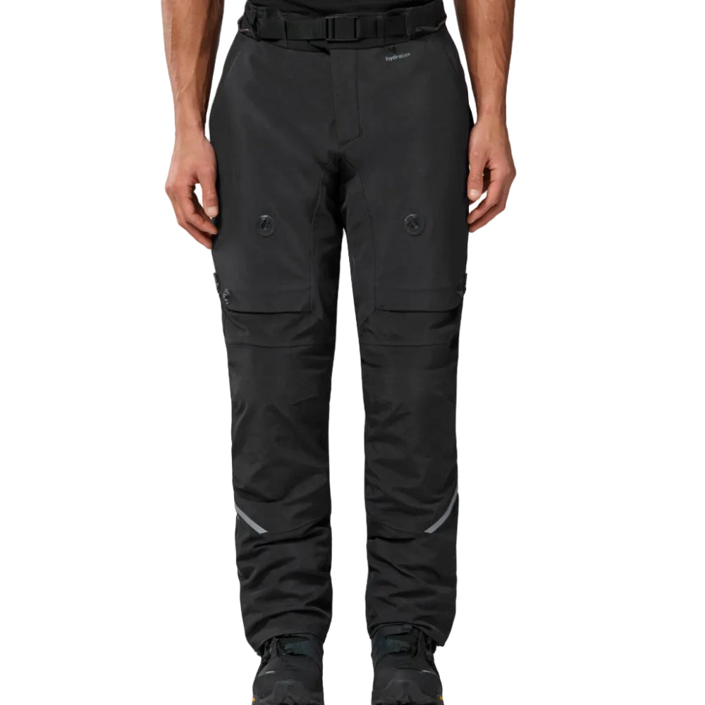 Black technical outdoor pants with a matching black belt, shown on a model from the waist down against a white studio background.