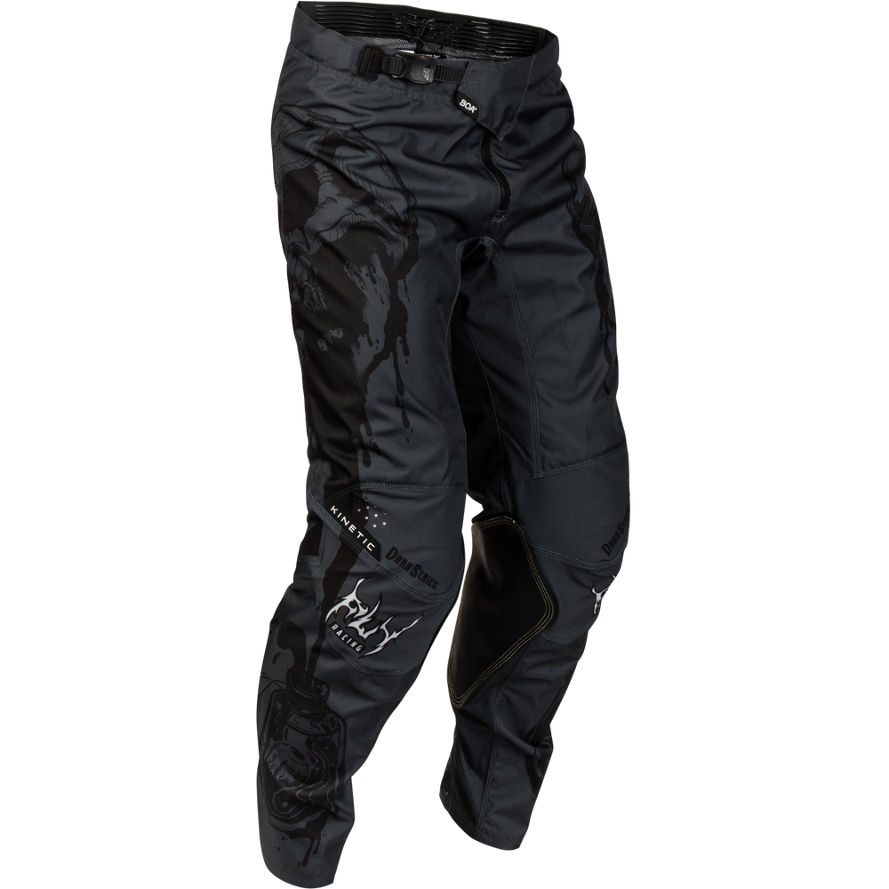 Black motocross pants with a subtle tonal camouflage pattern on the upper thigh, white 'FLY' branding on the lower left leg, and black knee pads attached on the right knee, shown against a plain white background.