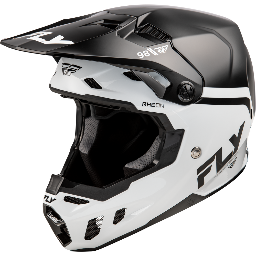 A white and black Fly Racing full-face motocross helmet with a matching visor, featuring the 'FLY' brand name and 'RHEON' model text on a clean white background.