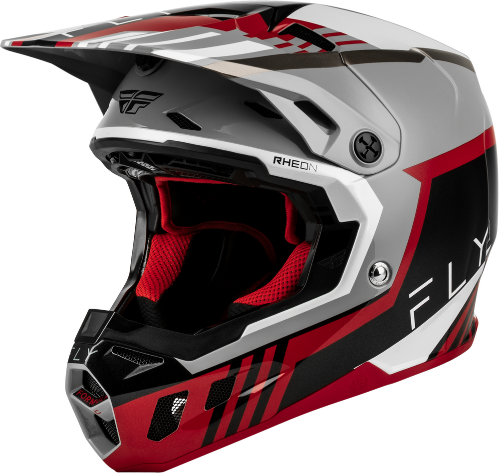 A Fly Racing full-face motocross helmet in a metallic silver, black, and red colorway. The helmet features the 'RHEON' model name on the side, a clear visor, and red interior padding.