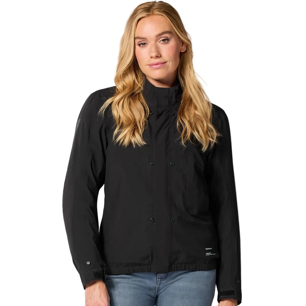 Woman wearing a black jacket and blue jeans on a white background