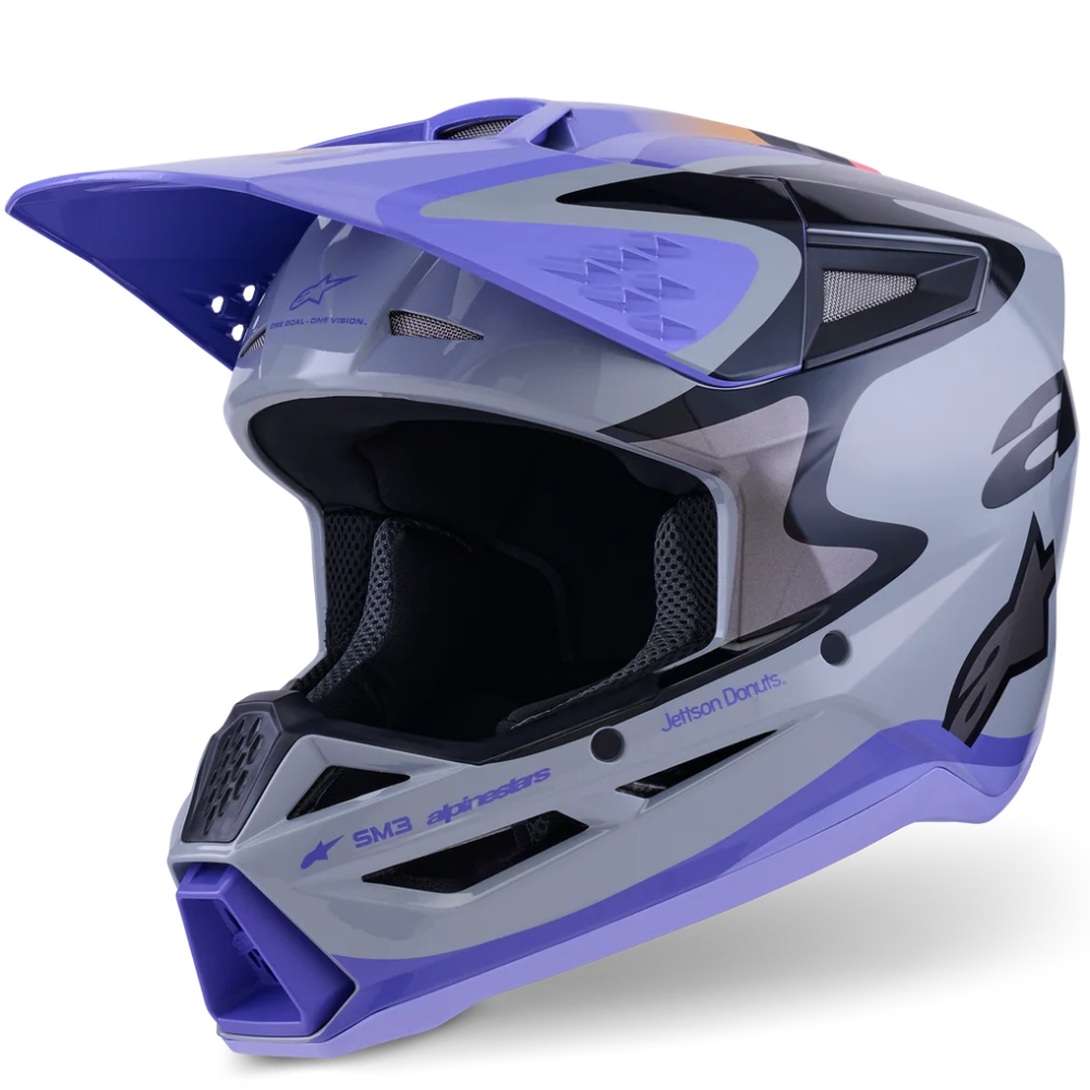 A full-face motocross helmet in a gray, white, and purple colorway, featuring a visor and a black interior, shown on a clean white background.