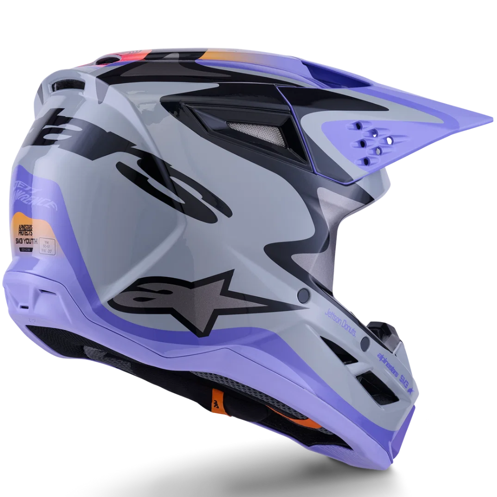 A full-face motocross helmet in a metallic silver-gray with purple and black graphics, featuring the Alpinestars logo, shown on a clean white background.