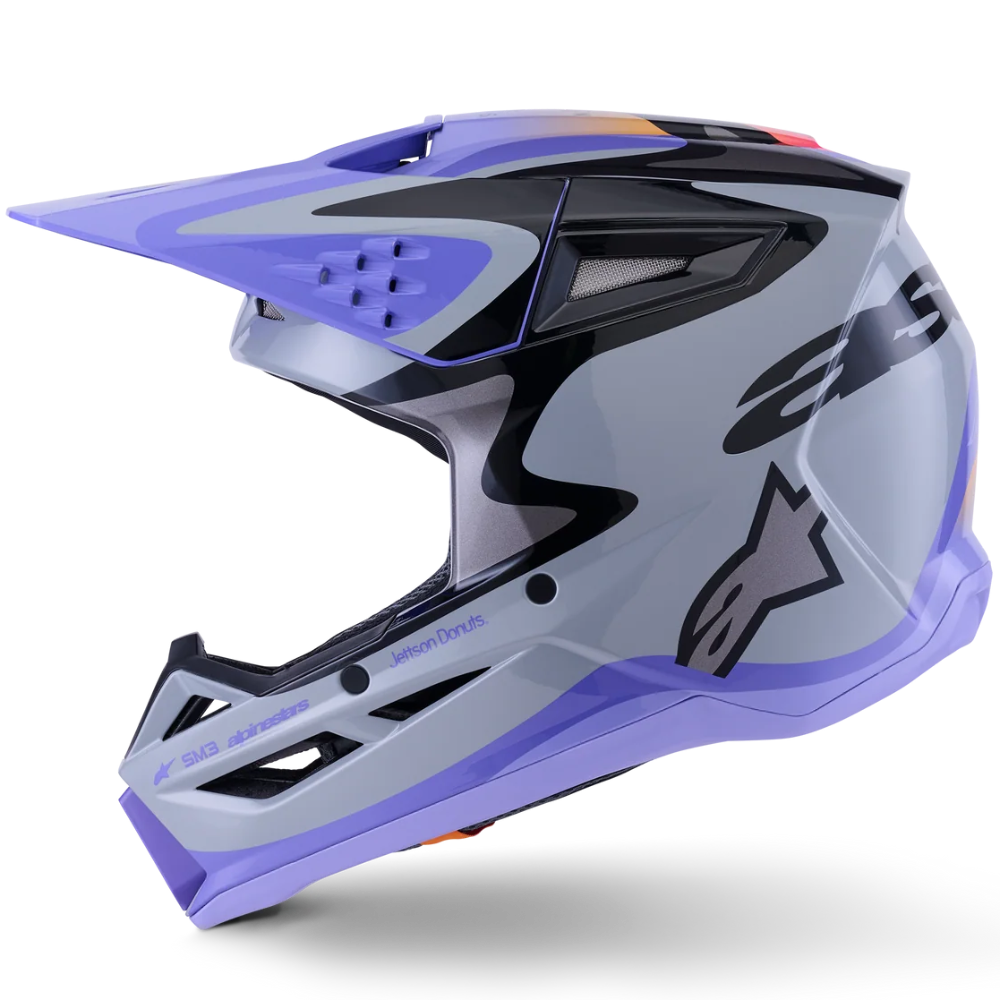 A side profile view of an Alpinestars dirt bike helmet in a light gray and lavender purple color scheme with black graphics, set against a plain white background.