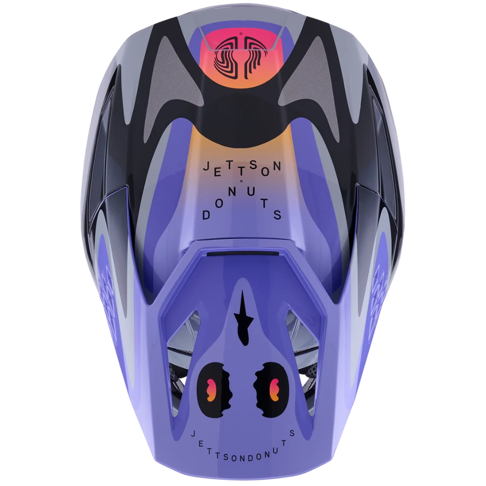 A custom purple and black motocross helmet with a skull graphic on the front and 'Jetson Donuts' branding, shown on a solid white background.