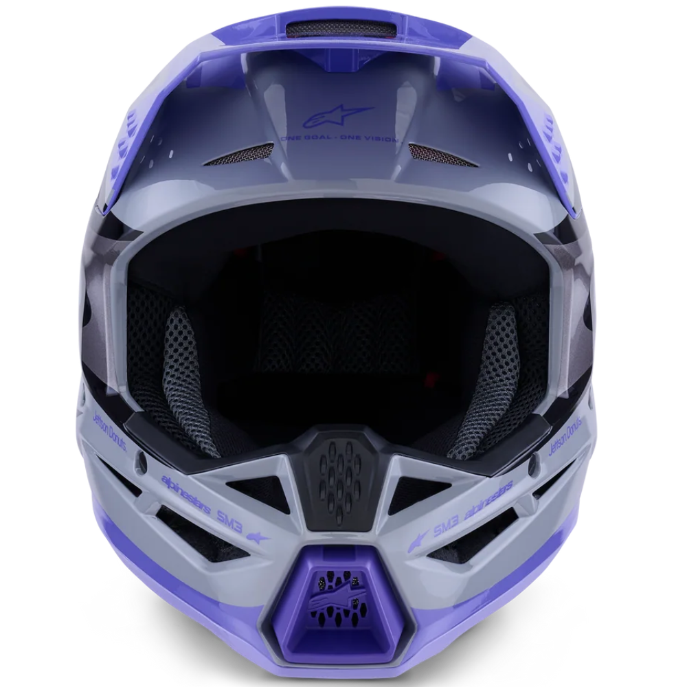 Front view of an Alpinestars full-face motocross helmet in a metallic purple and gray colorway, featuring a dark visor and black interior padding, set against a plain white background.