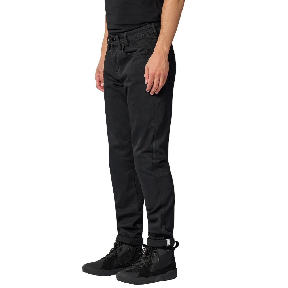 Person wearing black pants and black shoes on a white background