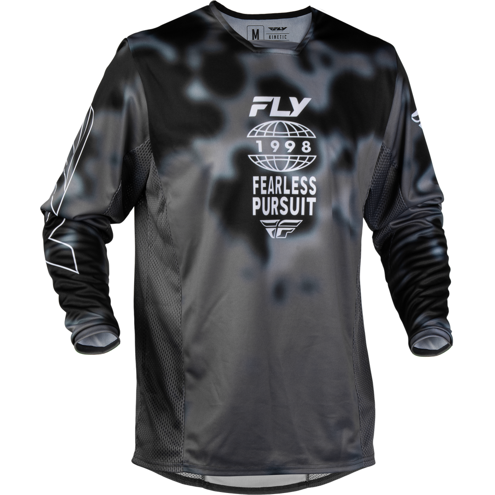 A long-sleeve motocross jersey in black and dark gray with a subtle mottled pattern, featuring a white graphic on the chest that reads 'FLY 1998 FEARLESS PURSUIT'.