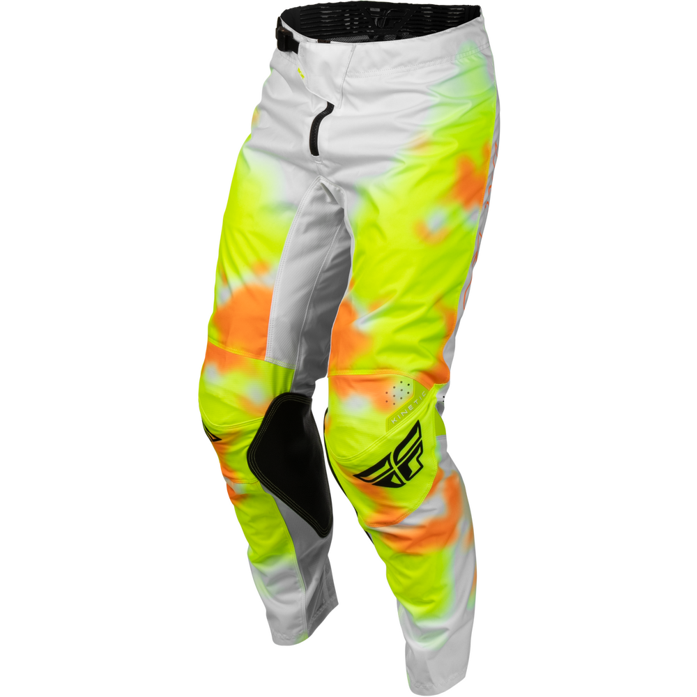 A pair of Fly Racing motocross pants featuring a high-visibility neon yellow, orange, and white tie-dye pattern with black knee pads and a black Fly logo on the lower left leg.