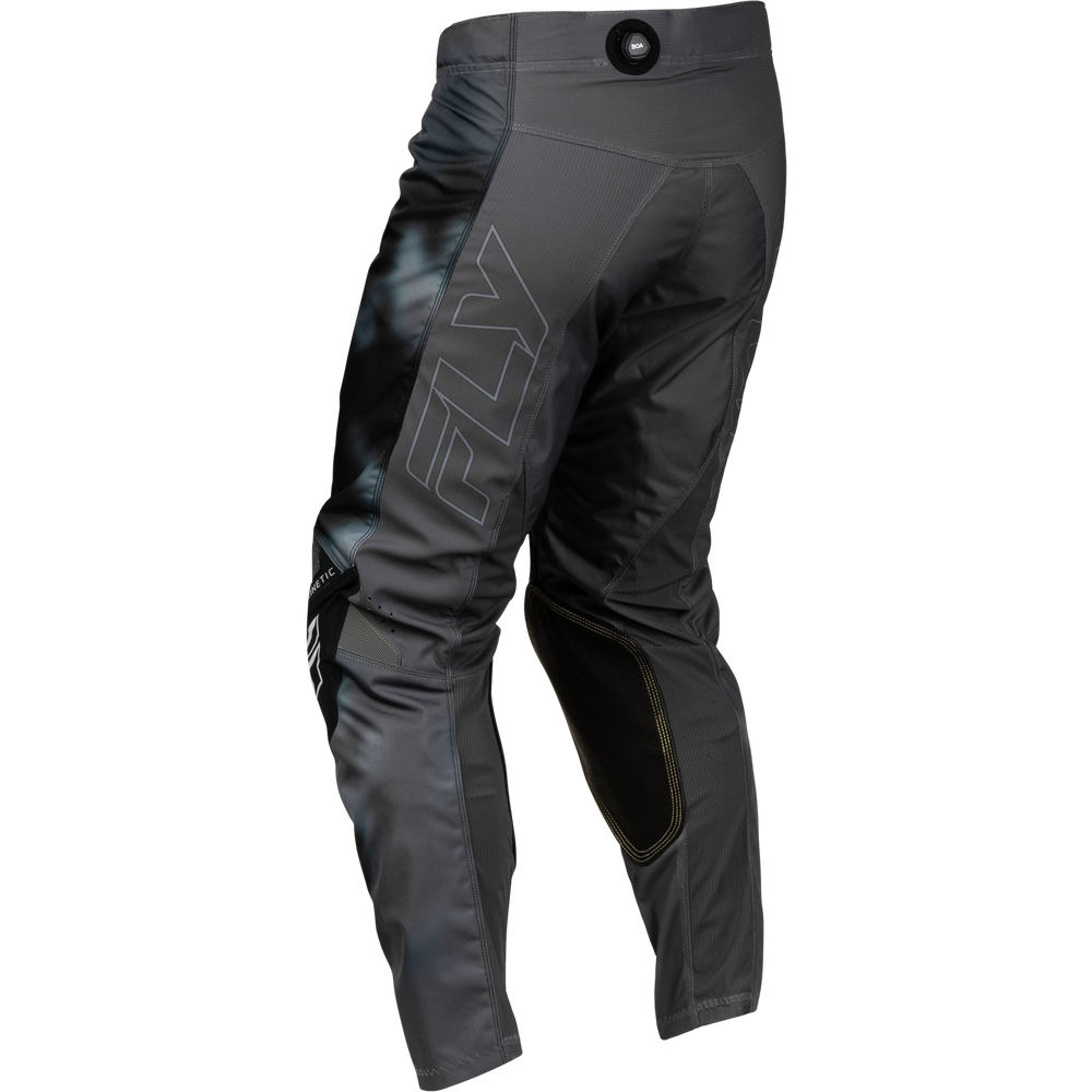 Black Fly Racing motocross pants with a subtle blue-gray gradient pattern on the left leg and a large white outlined 'FLY' logo on the side, shown from a three-quarters back angle on a white background.