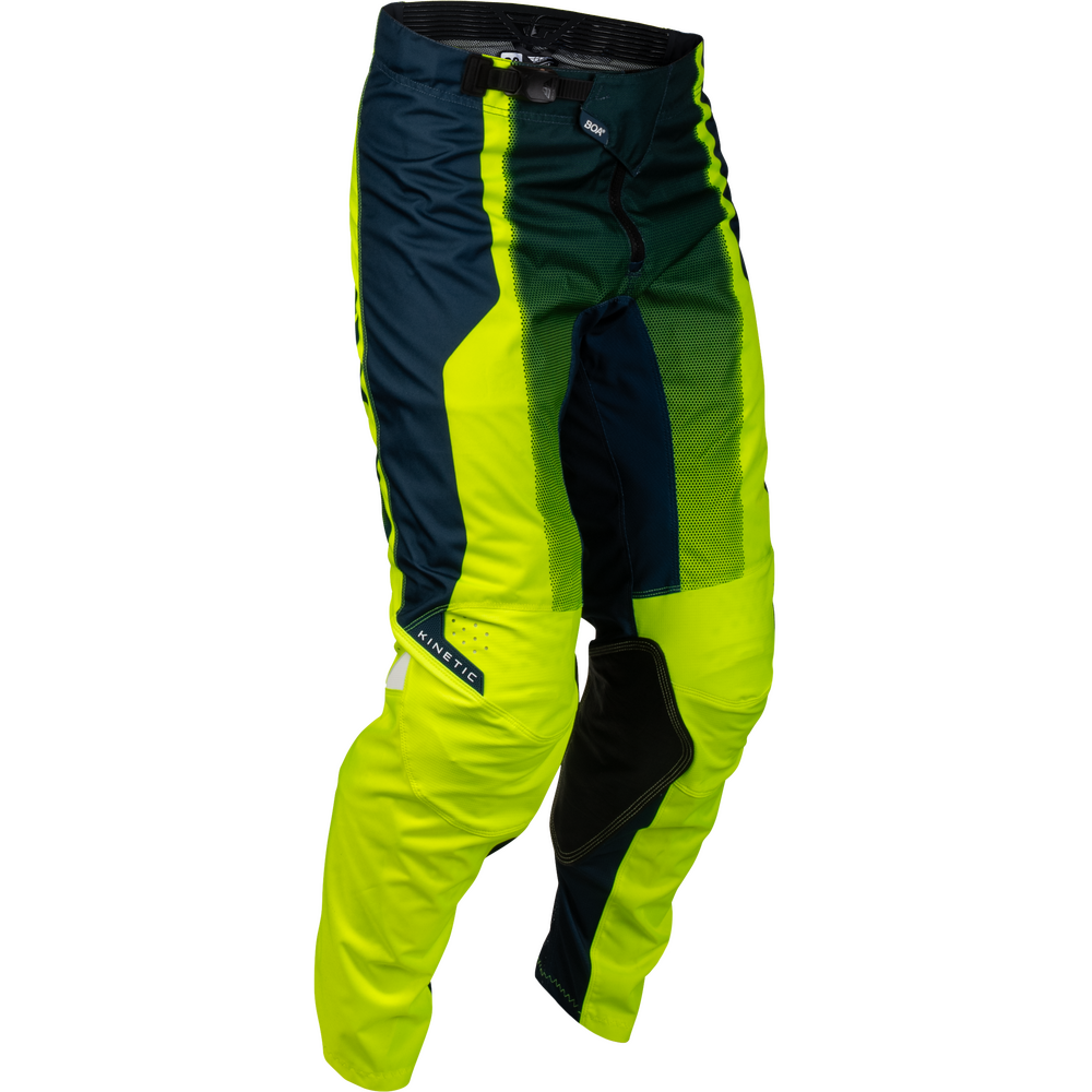 A pair of motocross pants in a high-visibility neon yellow-green, dark navy blue, and black colorway. The brand name 'Klim' is visible on a small white label on the lower left leg.