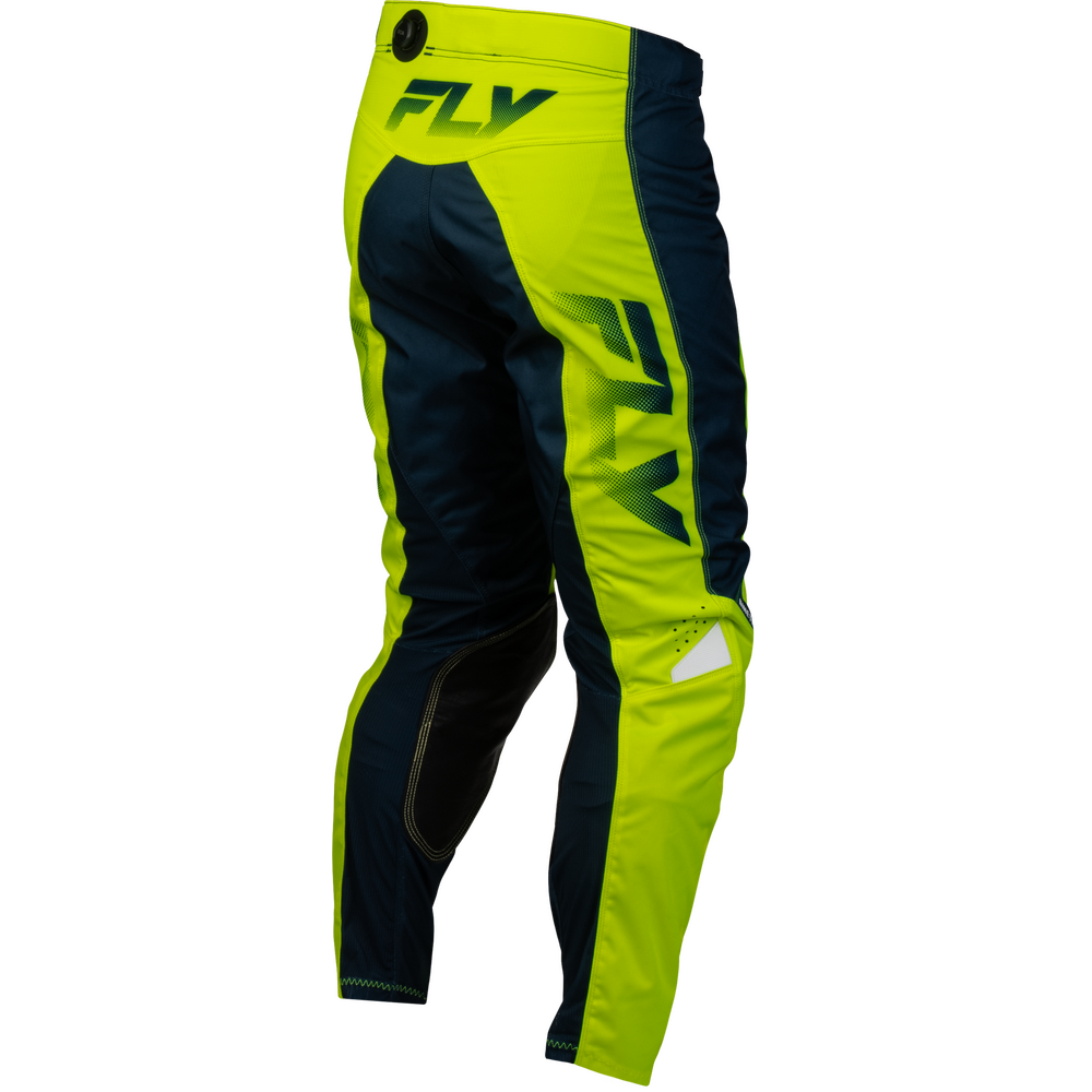 Fly motocross pants in neon yellow-green and navy blue, featuring a large vertical FLY logo on the leg and a small white reflective patch near the lower calf.