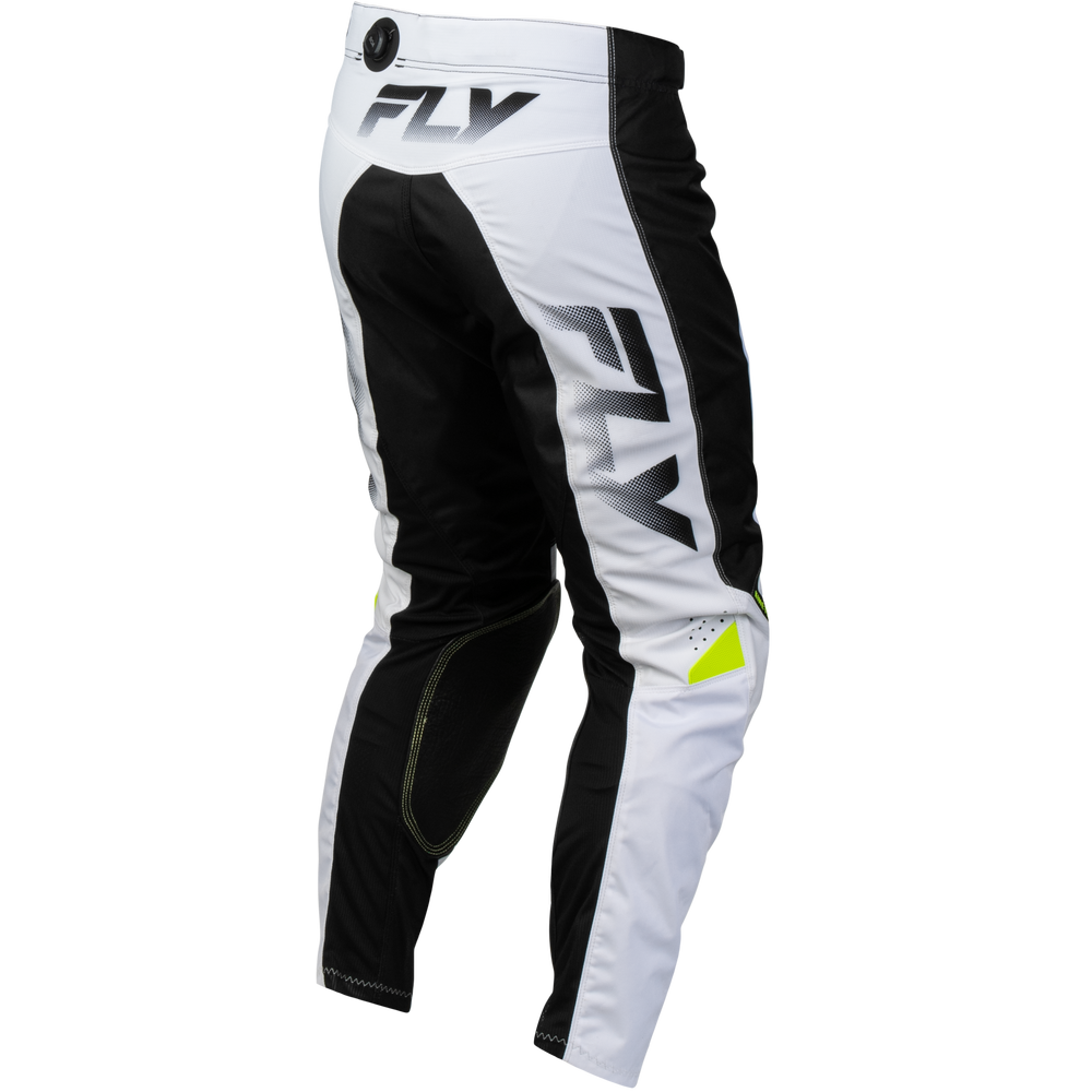 White and black motocross pants with a large gray 'FLY' logo on the thigh and a small neon yellow accent near the lower leg, shown on a plain white background.