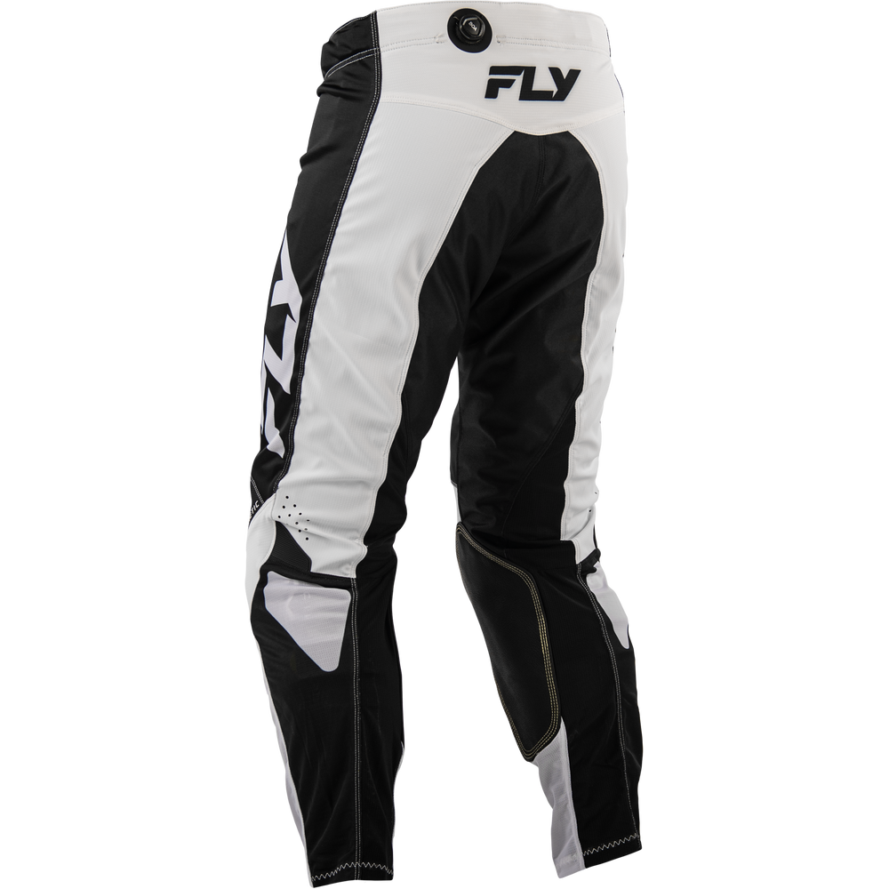 Black and white Fly motocross pants shown from the back, featuring a white waistband with a black FLY logo and a large white FLY logo printed vertically down the left leg.