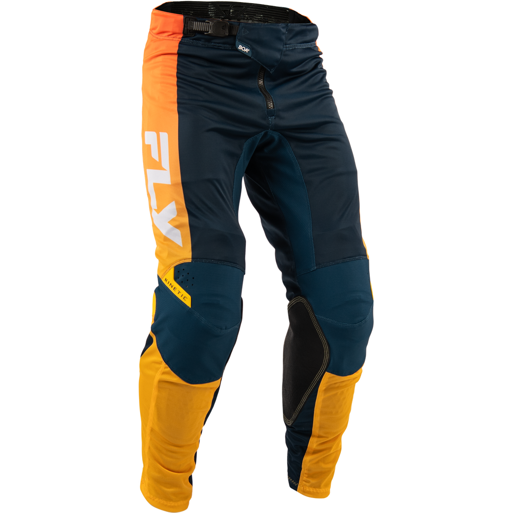 A pair of Fly Racing motocross pants in navy blue, bright orange, and yellow, featuring a large white 'FLY' logo on the side and black knee pads, shown on a plain white background.