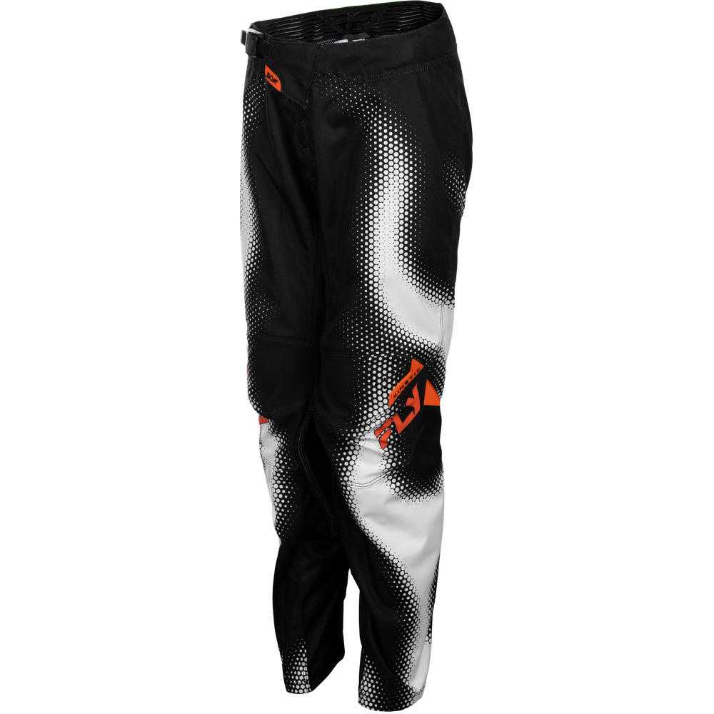 Black and white motocross pants with a halftone gradient pattern and orange logo accents, shown on a plain white background.