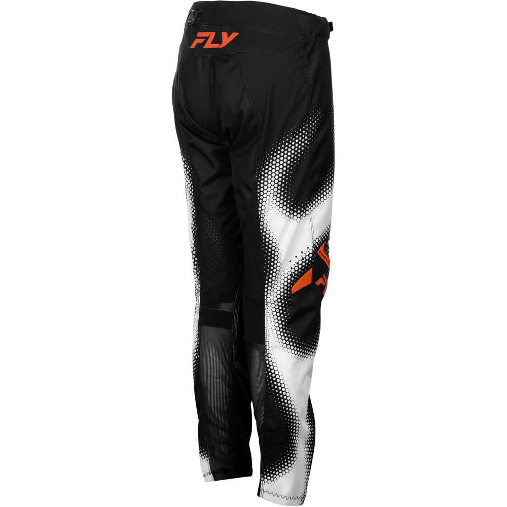 Black motocross pants with a white halftone gradient pattern and orange Fly brand logos, shown from the back on a white background.