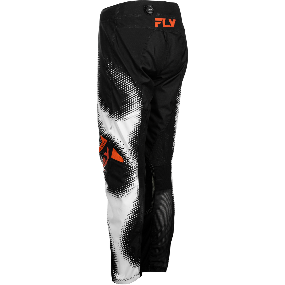 Black and white motocross pants with a halftone gradient pattern and orange FLY logo on the upper thigh and knee area, shown against a plain white background.