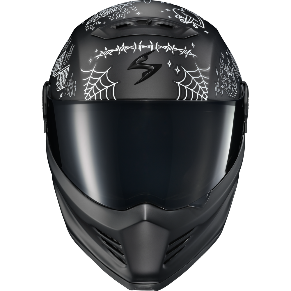 A matte black full-face motorcycle helmet with a glossy black visor, decorated with white spiderwebs, stars, and gothic-style script on the sides. The helmet is shown from a front-facing perspective against a solid white background.