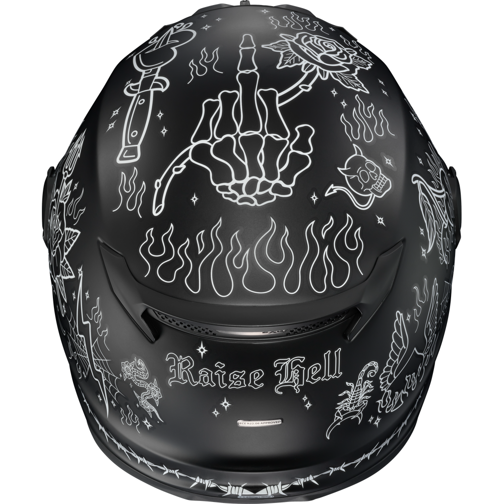 A matte black full-face motorcycle helmet decorated with white gothic and tattoo-style illustrations, including a skeletal hand holding a rose, flames, stars, and the text 'Raise Hell' on the lower front.
