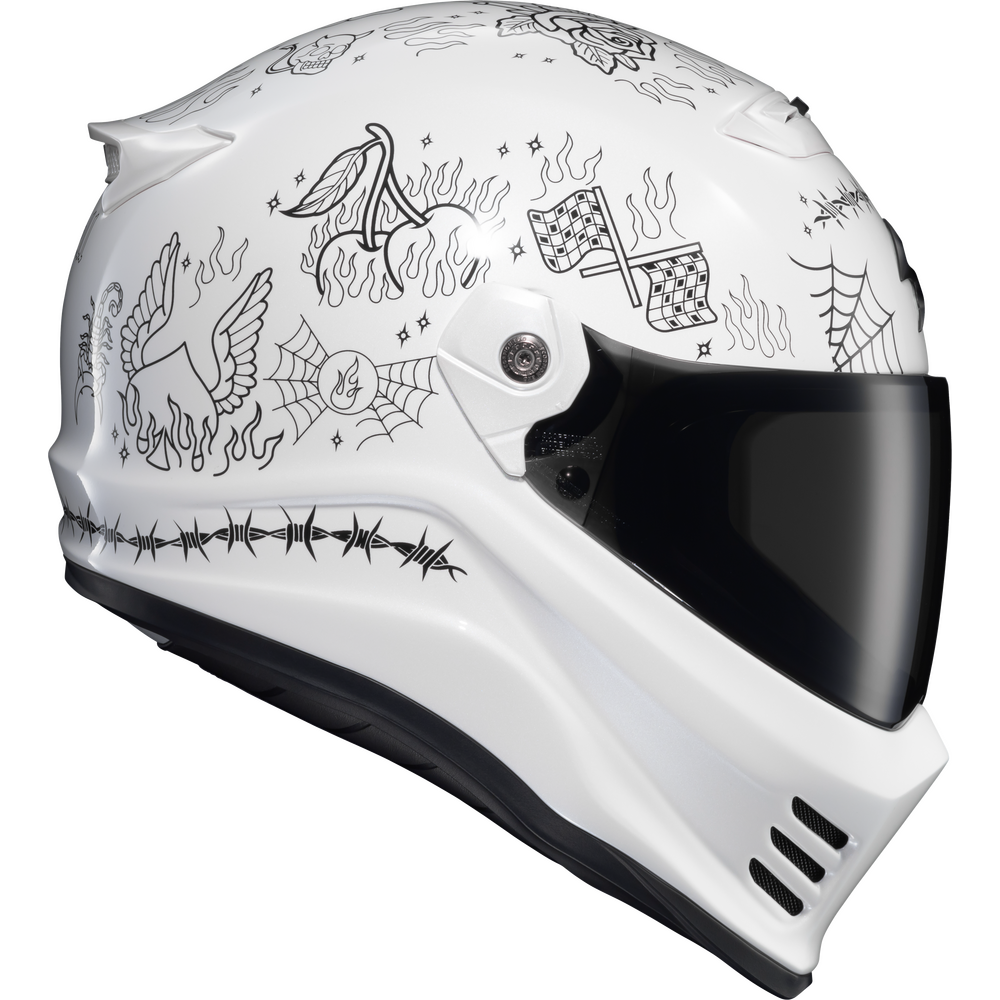 A white full-face motorcycle helmet with black line-art illustrations of a phoenix, spiderwebs, flames, and a checkered flag, featuring a dark visor.
