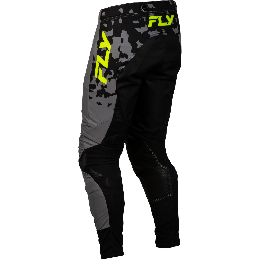 Black and gray motocross pants with a gray camouflage pattern on the upper thigh and bright neon yellow FLY logos on the side and hip, shown against a plain white background.