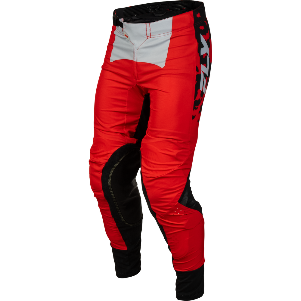 Red and black motocross pants with a white panel on the upper thigh and a black vertical logo on the side, shown on a white background.