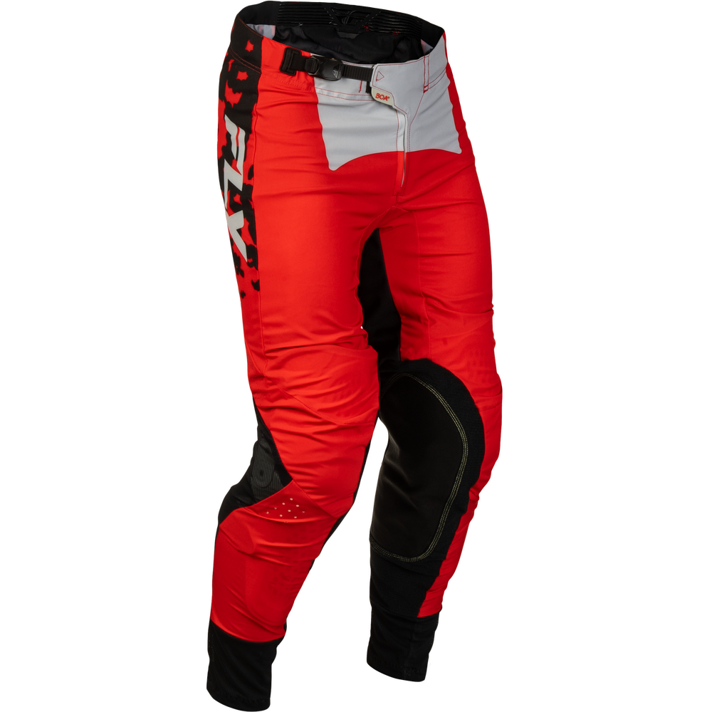Red and black motocross pants with a white panel on the upper thigh, shown on a white background.