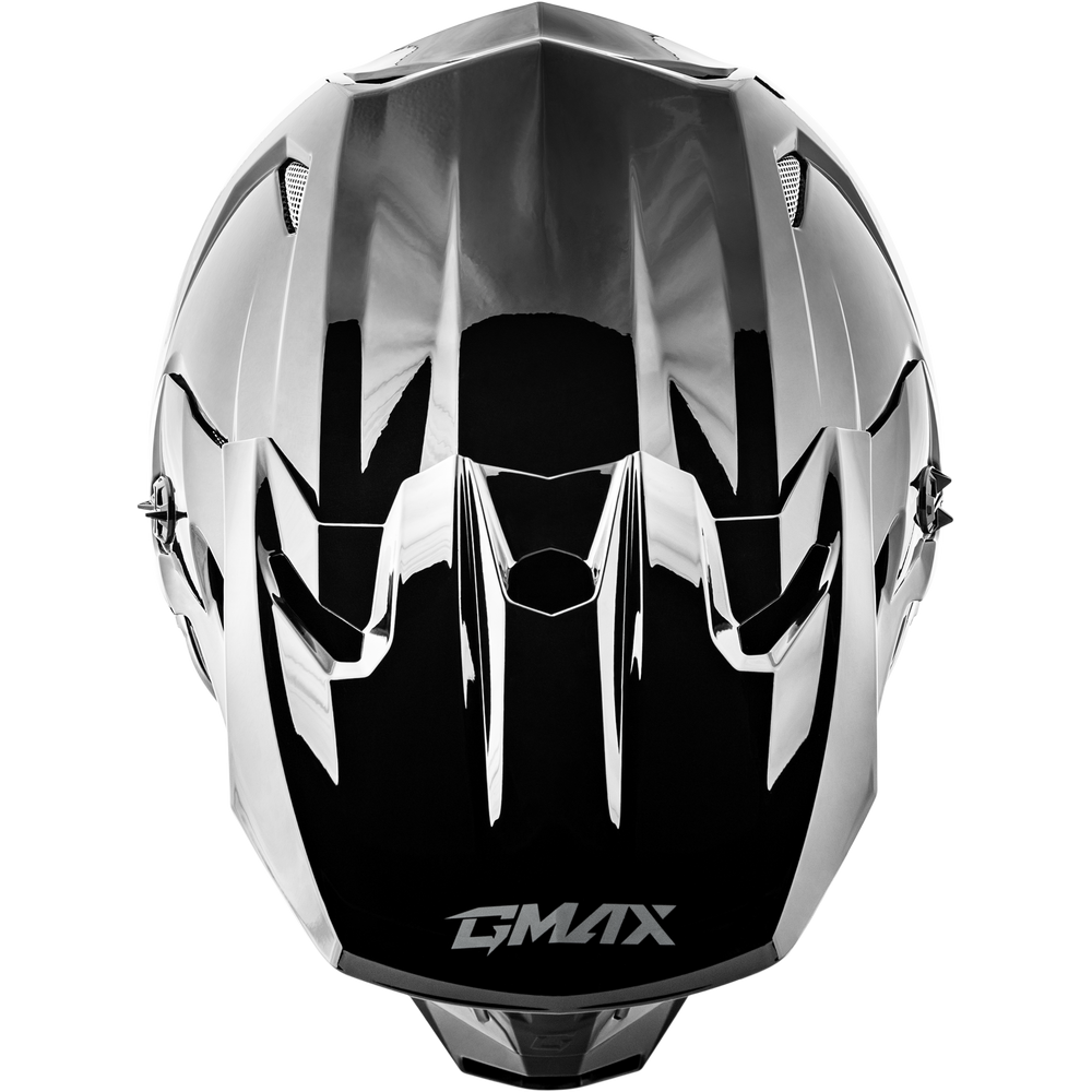 A glossy black and silver motocross helmet with a reflective chrome finish, featuring the GMAX logo on the lower front, set against a plain white background.