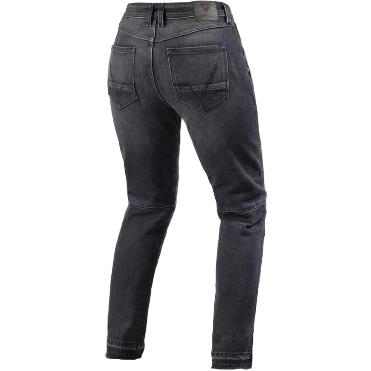 Rear view of dark gray washed skinny jeans on a light beige background.