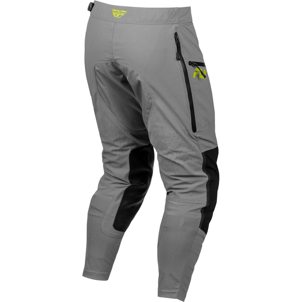 Gray technical riding pants with black knee and side panel inserts, a vertical zippered pocket on the left thigh, and a small yellow logo on the upper left hip and side pocket.