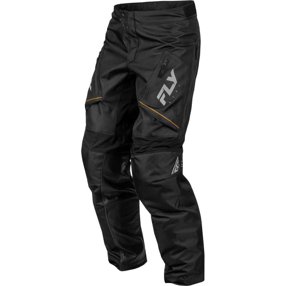 Black Fly Racing motocross pants with a large white logo on the upper left thigh and subtle yellow piping accents, shown on a plain white background.