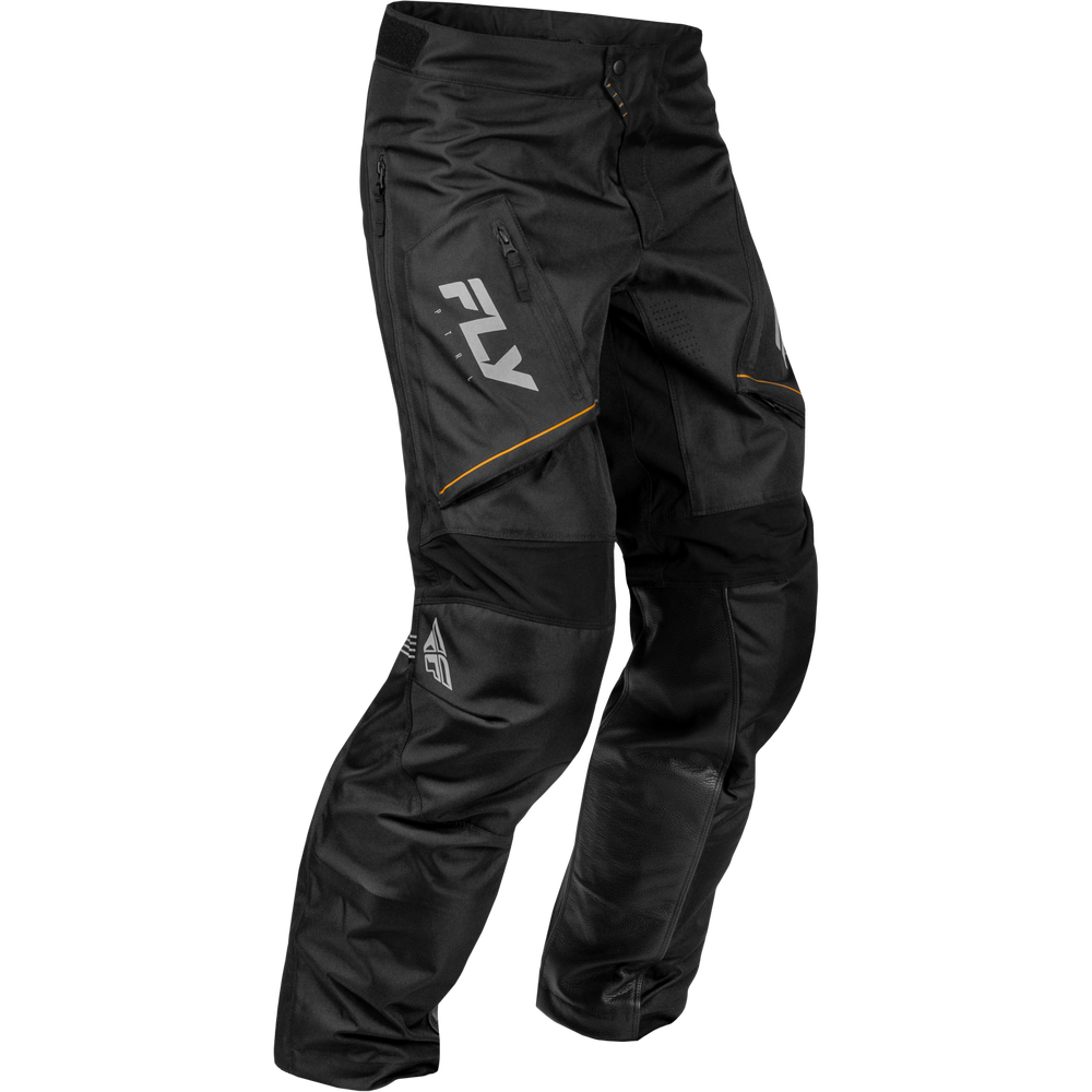 Black motocross pants with a large white FXR logo on the left thigh, a zippered pocket, and subtle orange piping details, shown on a plain white background.
