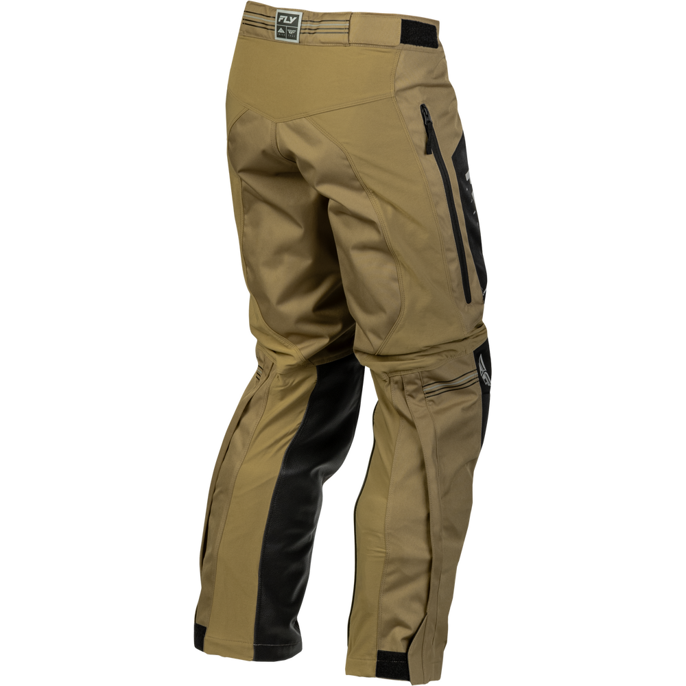 A pair of tactical pants in coyote brown with black side panels and black zipper details, shown from a three-quarters back angle on a white background.