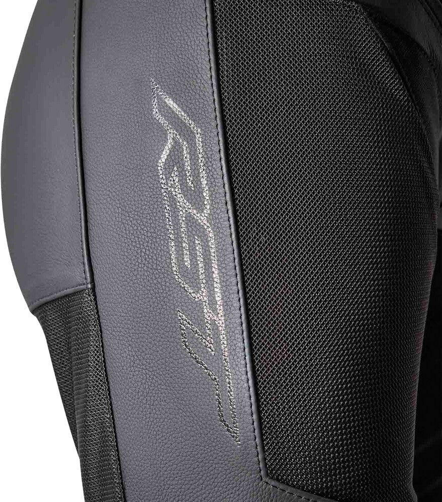 Close-up of a black and gray protective jacket with branding on a dark background