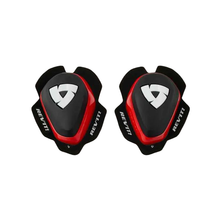 A pair of REV'IT! knee pads in black and red with a white logo, displayed side-by-side on a light beige background.