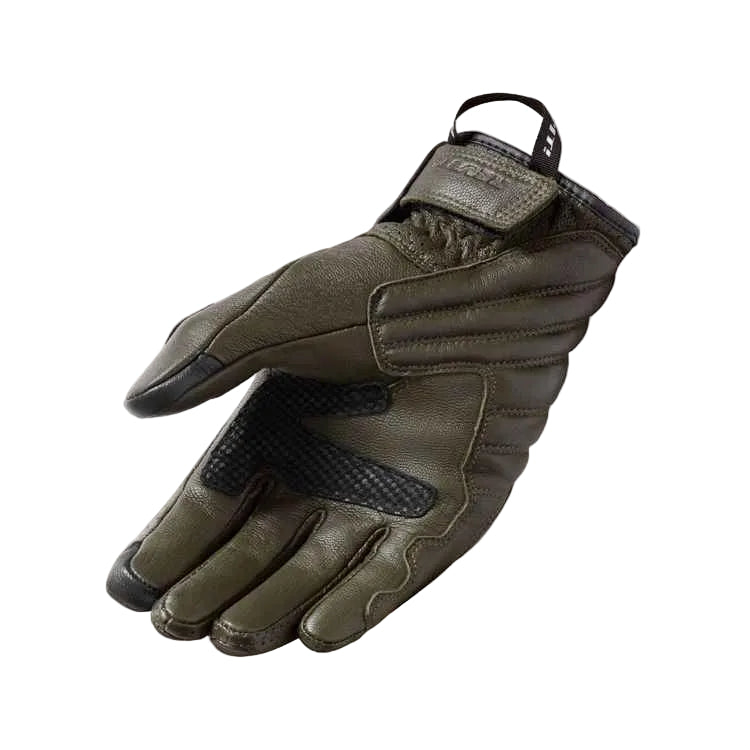 An olive green leather tactical glove with black accents on the fingertips, palm grip, and wrist strap, displayed on a light beige background.