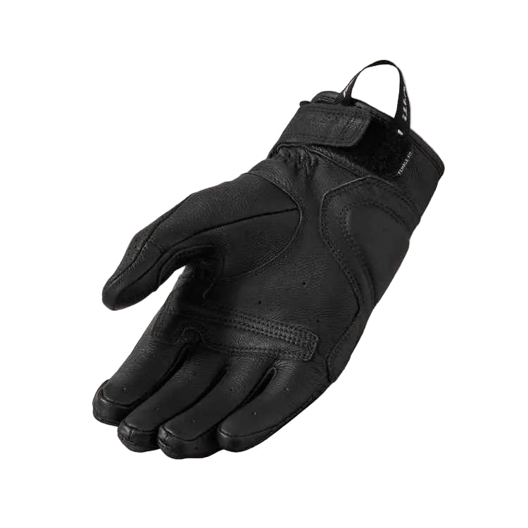 Black tactical glove on a light gray background