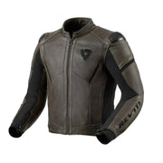 A dark brown leather motorcycle jacket with black protective panels and the REV'IT! brand name printed on the left sleeve, shown against a light off-white background.