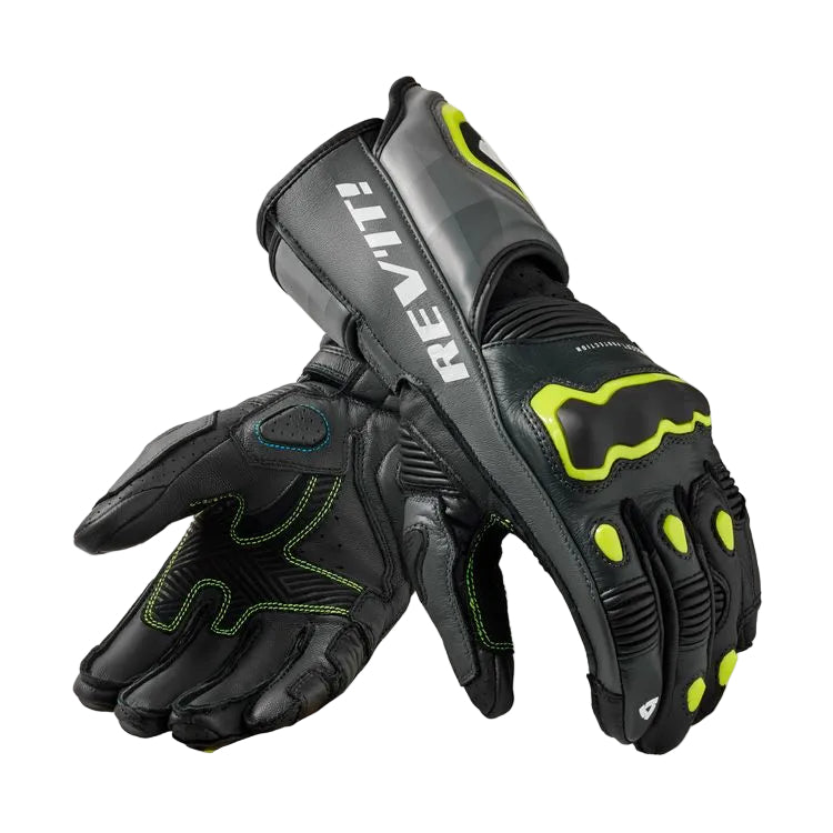 Black and gray gloves with green accents on a white background, featuring the Rev'it logo.