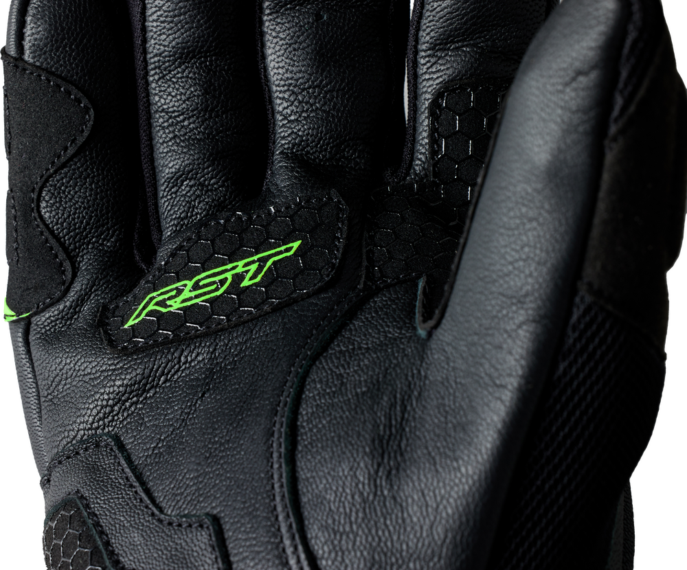 Black motorcycle glove with green 'RST' logo on a white background