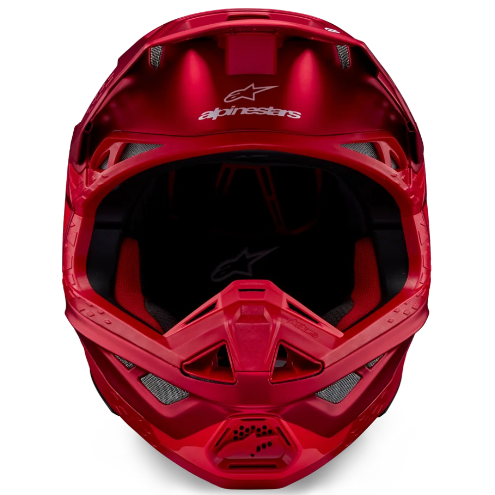 Red motorcycle helmet with 'Alpinestars' branding on a white background