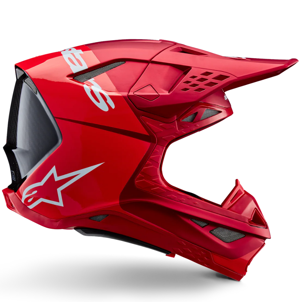 Red motocross helmet with a white logo on a white background